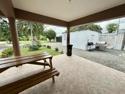 a bench on a patio with a view of a backyard at Villa San Pedro in San Pedro de Macorís