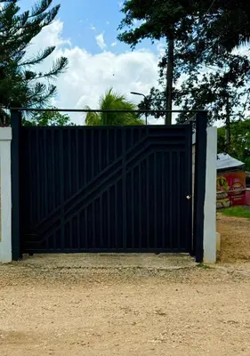 a black gate in front of a house at Villa San Pedro in San Pedro de Macorís