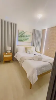a bedroom with two beds with white sheets and curtains at Coral Blue Apartment- Dominicus in La Laguna