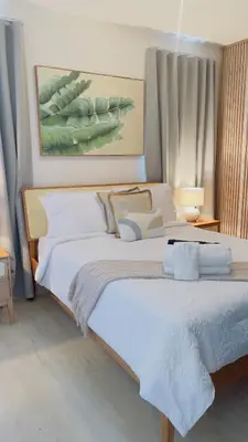 a bedroom with a large bed with white sheets at Coral Blue Apartment- Dominicus in La Laguna