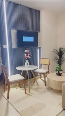 a room with a table and two chairs and a tv at Coral Blue Apartment- Dominicus in La Laguna