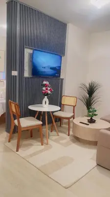 a living room with a table and chairs and a tv at Coral Blue Apartment- Dominicus in La Laguna