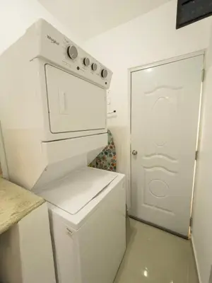 a kitchen with a white stove and a white refrigerator at Encanto - La Romana near Caleta beach in La Romana