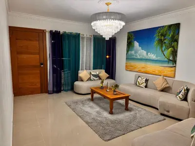 a living room with a couch and a table at Exclusive Huge and Lovely 4 bedrooms and 3 bathrooms apartments in Santiago close to all funs in Santiago de los Caballeros