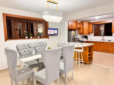 a kitchen and dining room with a table and chairs at Exclusive Huge and Lovely 4 bedrooms and 3 bathrooms apartments in Santiago close to all funs in Santiago de los Caballeros