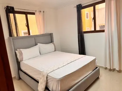 a small bed in a room with a window at Exclusive Huge and Lovely 4 bedrooms and 3 bathrooms apartments in Santiago close to all funs in Santiago de los Caballeros