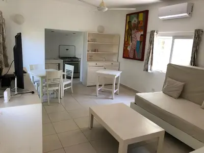 a living room with a couch and a table at Cosy Apartment 1 bedroom, swimming pool and beach 30m in Las Terrenas