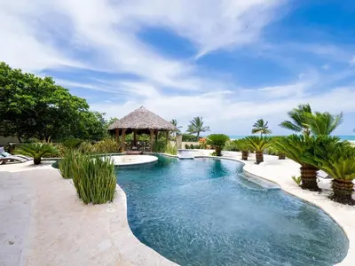 a swimming pool in a resort with a gazebo at Villa Emoción Del Mar - Beachfront Luxury Villa
