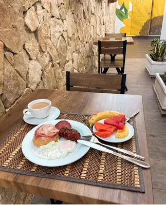a table with two plates of breakfast food on it at Hotel Montesilva in Puerto Plata