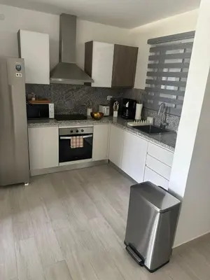 a kitchen with a refrigerator and a stove top oven at Escape perfecto, punta cana in Punta Cana