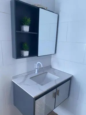 a bathroom sink with a mirror and two potted plants at Mi Rinconcito in Colorado