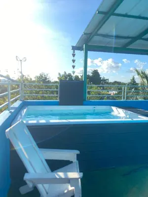 a blue swimming pool with a chair and a chair at Mi Rinconcito in Colorado