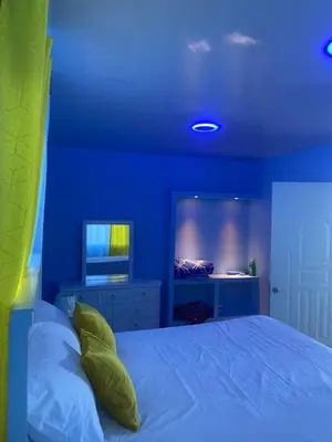 a blue bedroom with a bed and a television at Mi Rinconcito in Colorado