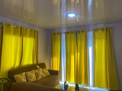 a living room with yellow curtains and a couch at Mi Rinconcito in Colorado
