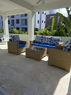a patio with couches and a table and chairs at Villa with Pool Terrace and 3 minutes to the beach in Puerto Plata
