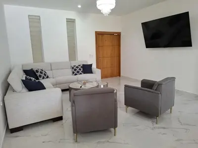 a living room with a couch and two chairs at Villa with Pool Terrace and 3 minutes to the beach in Puerto Plata