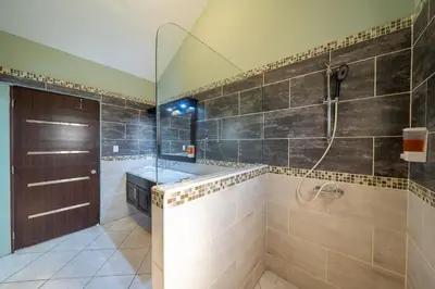 a large bathroom with a shower and a sink at 6BR, Jacuzzi, Ocean View, Solar Backup Power in Sosúa