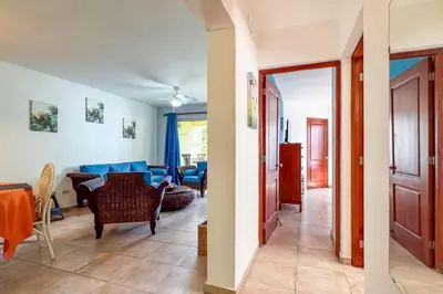 two views of a living room and a dining room at Renaissance Residence Cabarete in Cabarete