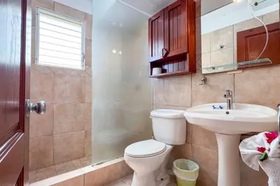 a bathroom with a toilet and a sink at Renaissance Residence Cabarete in Cabarete