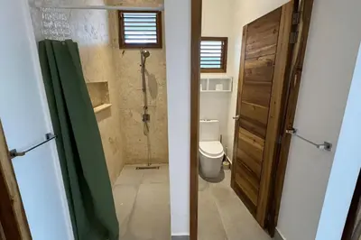 a bathroom with a shower and a toilet and a door at 5 Bedroom Villa With BBQ and Washer in Las Terrenas
