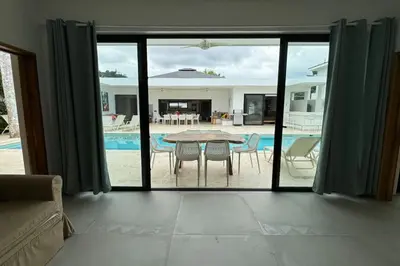 a living room with a view of a table and a pool at 5 Bedroom Villa With BBQ and Washer in Las Terrenas