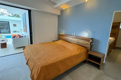 a bedroom with a bed and a large window at 5 Bedroom Villa With BBQ and Washer in Las Terrenas