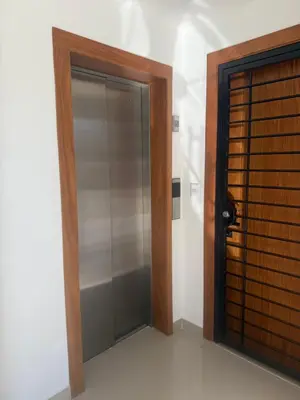 a glass door in a room next to a wall at Luxurious Apartment in Santiago de los Caballeros
