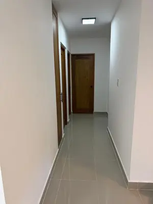 an empty hallway with a door and a tile floor at Luxurious Apartment in Santiago de los Caballeros