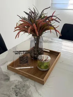 a wooden tray with a vase with a plant on it at Luxurious Apartment in Santiago de los Caballeros