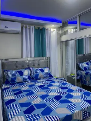 a blue and white bed with blue and white pillows at Moderna casa cerca del aeropuerto SDQ y de mi rent cars in La Caleta
