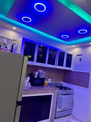 a kitchen with green lights on the ceiling at Moderna casa cerca del aeropuerto SDQ y de mi rent cars in La Caleta