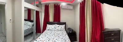 a bedroom with a bunk bed with red curtains at Moderna casa cerca del aeropuerto SDQ y de mi rent cars in La Caleta