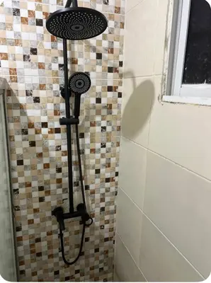 a shower in a bathroom with a tiled wall at Moderna casa cerca del aeropuerto SDQ y de mi rent cars in La Caleta