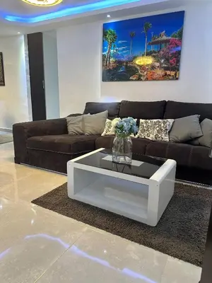 a living room with a couch and a white coffee table at Cozy Santo Domingo Apartment in San Isidro in Juan López