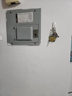 a microwave hanging on a wall in a kitchen at Garden II in Boca Chica