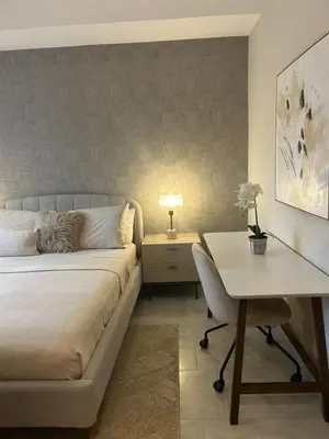 a bedroom with a bed and a desk and a table at REFA - 404 · Luxury 1BR Suite in Piantini | Modern • Pool • Gym in Santo Domingo