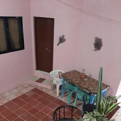 a room with a table and a chair and a door at B&B KeisyAlba Punta Rucia in Punta Rucia