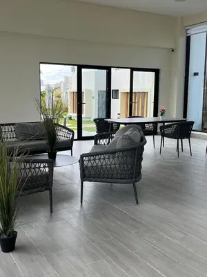 a living room with chairs and a table and windows at Villa Medrano