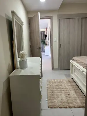 a bedroom with a white dresser and a bed at Villa Medrano