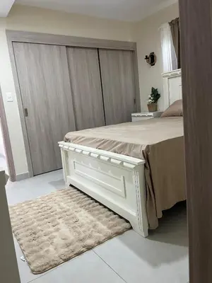 a bedroom with a white bed and a rug at Villa Medrano