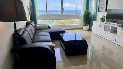 a living room with a couch and a table at Malecón view mar apartment in Colorado