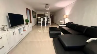 a living room with a couch and a flat screen tv at Malecón view mar apartment in Colorado