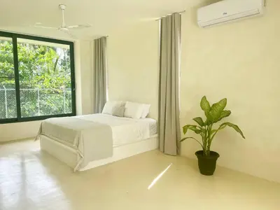 a bedroom with a white bed and a potted plant at Luxury Family Villa With Pool Near Playa Bonita in Las Terrenas