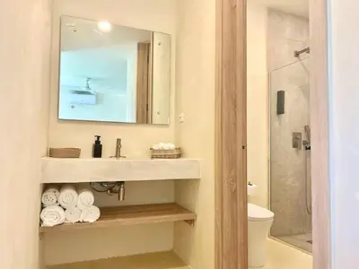a bathroom with a sink and a mirror and a toilet at Luxury Family Villa With Pool Near Playa Bonita in Las Terrenas