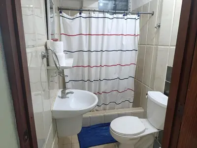a bathroom with a toilet and a sink and a shower at Hotel Don Michele in Boca Chica
