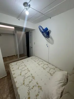 a bedroom with a bed with a blue phone on the wall at Residencial JG in Punta Cana