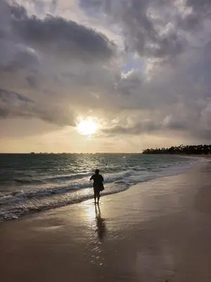 a person walking on the beach near the ocean at La belle planque de Punta Cana- Playa 10 minutos a pie in Punta Cana