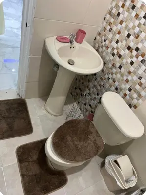 a bathroom with a toilet and a sink at Moderna casa seca de aeropuerto SDQ y de mi rent cars in La Caleta