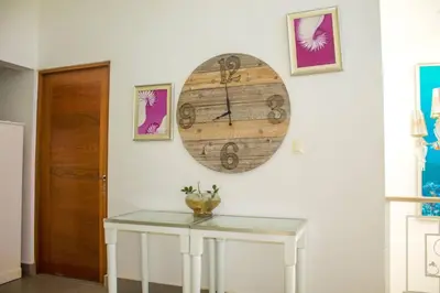 a room with a table and a clock on the wall at City Sea Exclusive Colonial Gem with Ocean View in Santo Domingo