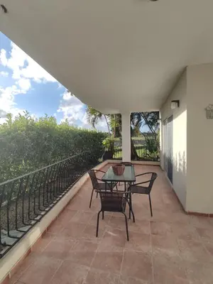a patio with a table and chairs on a balcony at Residencial El Carey in Punta Cana
